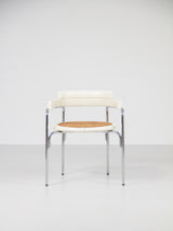 Juego de cuatro sillas de tubo de acero y ratán