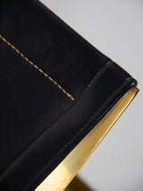 Taburete plegable en hierro y piel negra